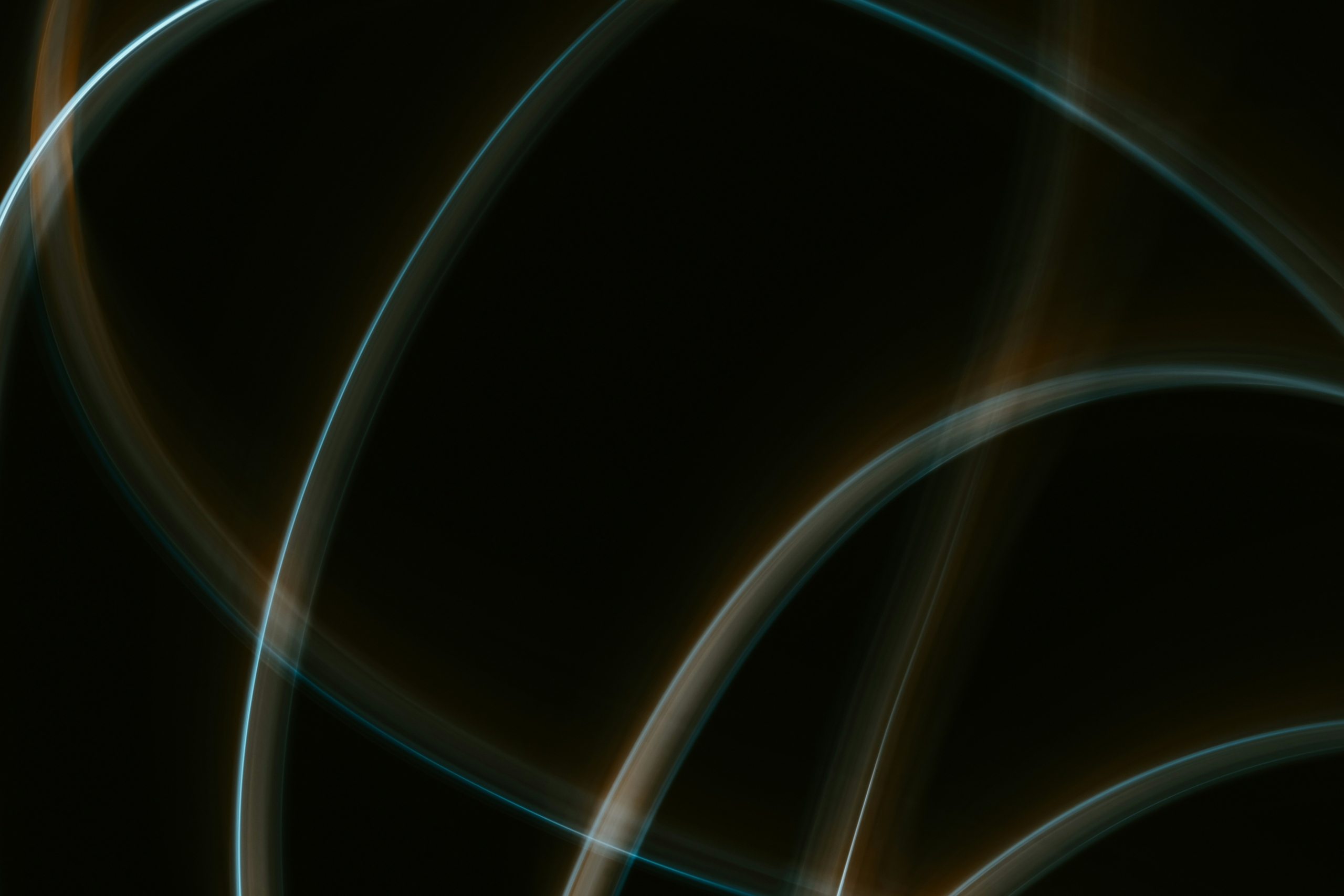 Abstract image with intersecting glowing lines in blue and orange on a dark background.