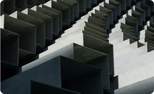 Close-up view of a modern building's exterior featuring repetitive, angular metal architectural elements.