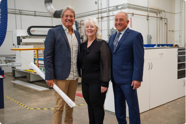 the ares team standing in their manufacturing room with patty