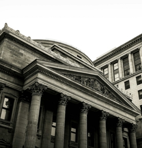 looking up at a federal bank building in a busy city