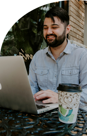 man working on computer at coffee shop