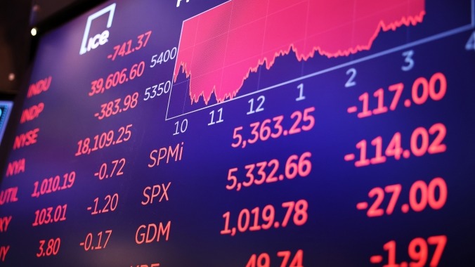 Stock market display showing a red graph with declining numbers and indices.