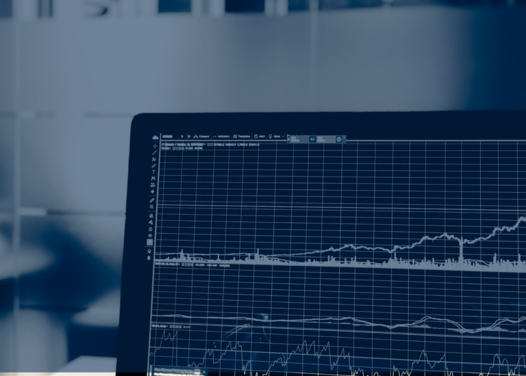 A laptop screen displaying financial graphs, including line charts depicting trends in housing starts over time.